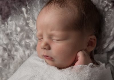 Baby boy on white wool background