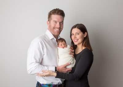 Parents holding newborn baby boy at his newborn photoshoot Northampton