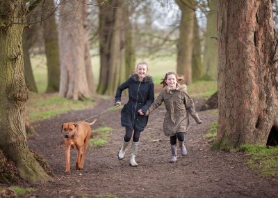Dog running on lead with children on Towcester photography session