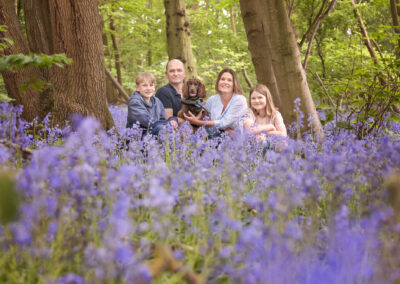 Family in the bluebells in Northamptonshire by Miranda Walton Photography