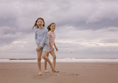 Sisters on the beach by Miranda Walton Photography