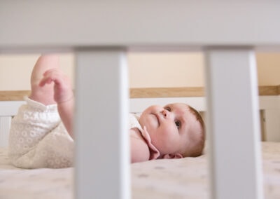 Day in the Life Photography - at home in Northamptonshire baby in cot lying down