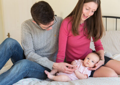 Day in the Life Photography - at home in Northamptonshire parents with baby on the bed