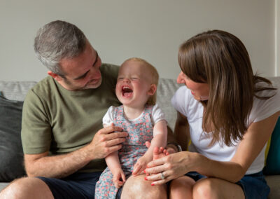 Day in the Life Photography - at home in Northamptonshire family of three laughing on sofa