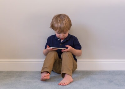Day in the Life Photography - at home in Northamptonshire boy with iPad sitting on the floor
