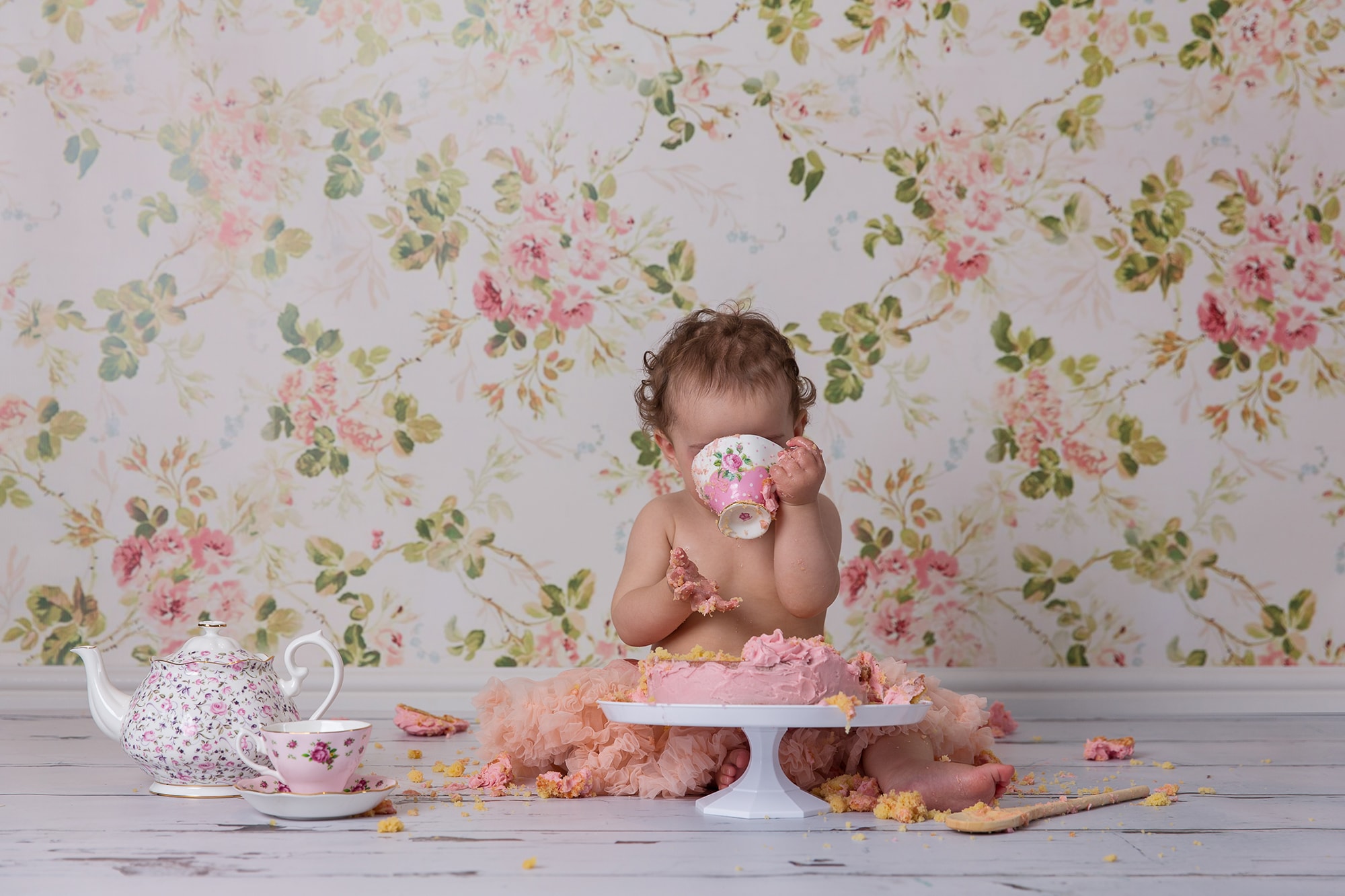 cake smash photoshoot with little girl and tea party theme