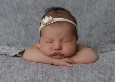 newborn baby girl on grey background