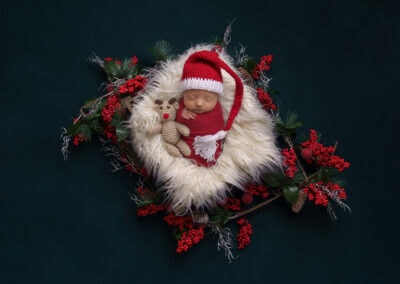 newborn baby dressed in Christmas outfit