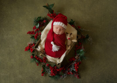 newborn baby dressed in Christmas outfit