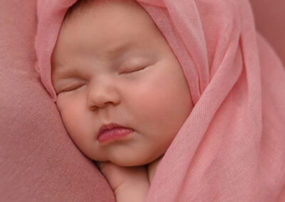 newborn photography on pink wrap