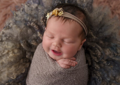 newborn photography with smiling baby